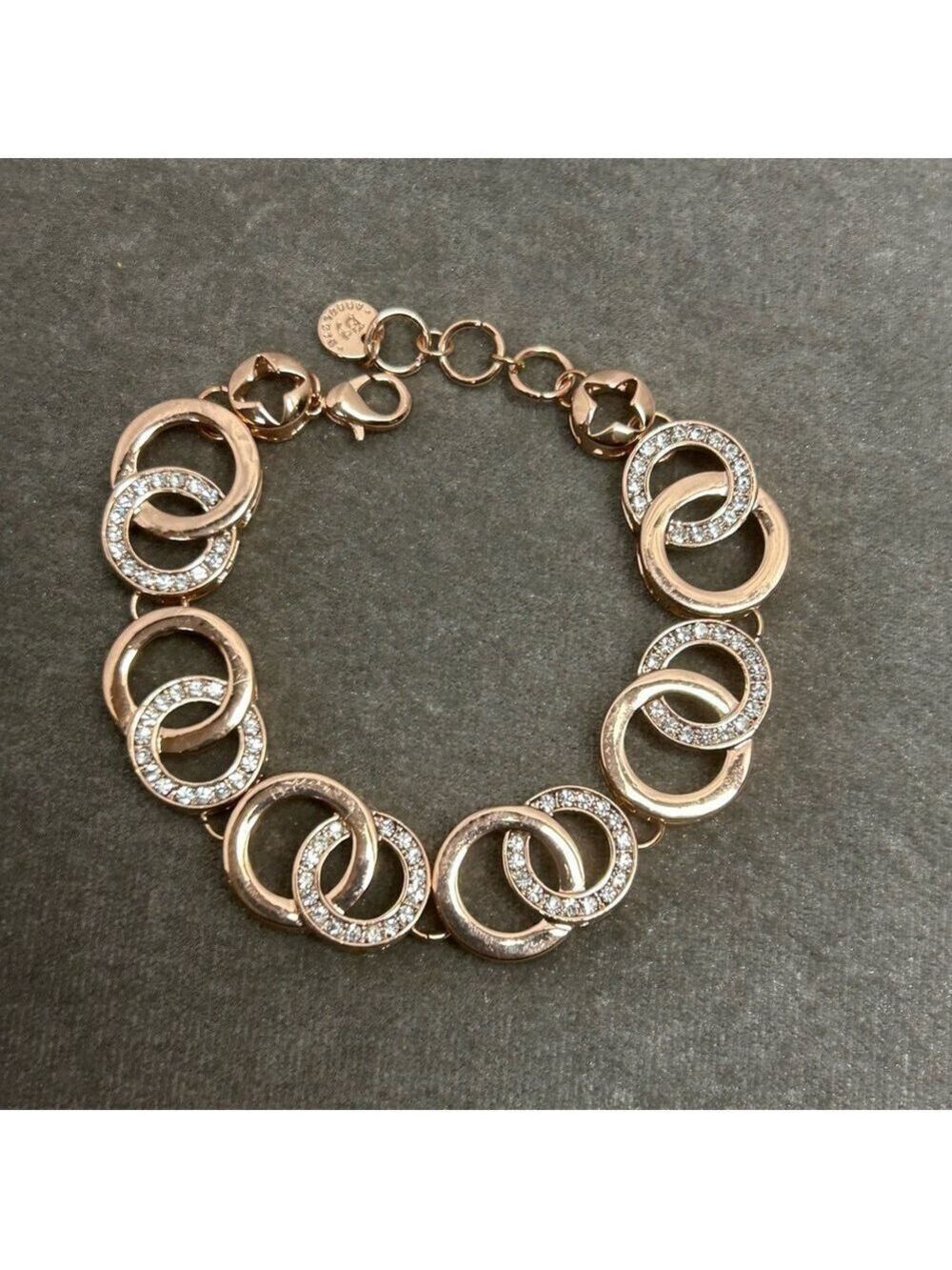 Absolute rose gold tone circular interlocking chain-link rhinestone bracelet